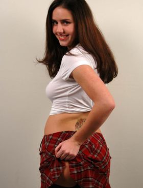 Long hair schoolgirl Kacey Kox gives sneak peek on her ass by lifting skirt