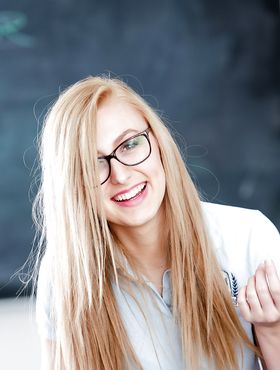 Young blonde nerd in glasses Alexa Grace posing in schoolgirl uniform