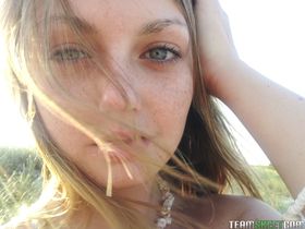 Elegant blue eyed teen Staci Silverstone flashes shaved pussy upskirt on beach