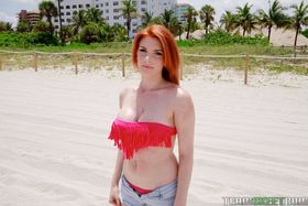 Redhead bombshell Rainia Belle flashing with her round melons and amazing ass