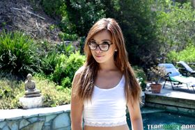 Alluring teen Kaylee Haze gets naked outdoors near the swimming pool