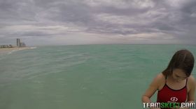 Teen babe Kimber Lee flashing large natural tits in the ocean