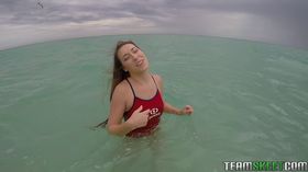 Teen babe Kimber Lee flashing large natural tits in the ocean