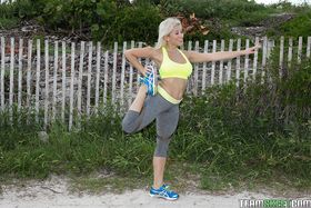 Blonde babe Cristi Ann models outdoors in yoga pants during sports workout