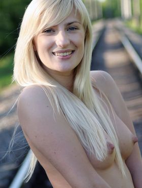 Leggy blonde Margo H strips to ankle strap heels on railway tracks