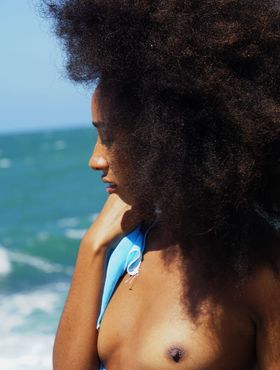 Black girl with a big fro Isadora shows her bald slit and hot ass by the ocean