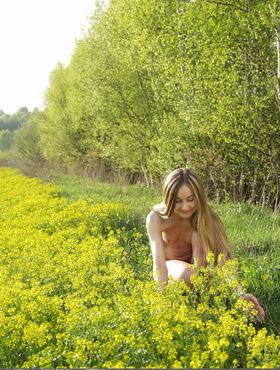 Pleasant teen Julette likes to walk in blossoming nature being naked