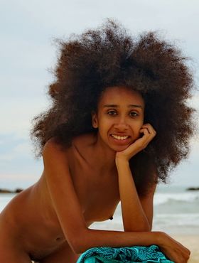 Slim black teen with big hair Isadora touts her hot ass in the nude on a beach