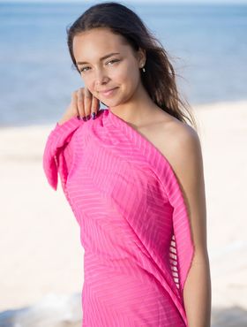 Sweet teen Slava A frees tan lined body from pink wrap on a beach