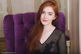Pale redhead Jia Lissa pets her landing strip pussy with her legs spread