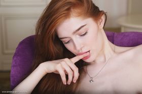 Fair skinned redhead Jia Lissa pets her trimmed pussy while totally naked