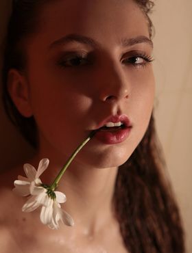Sultry teen Valery Leche gets into a petal filled tub after removing lingerie