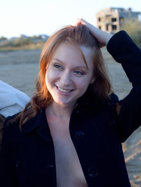 Redhead teen Nomi A models naked in 14 hole Docs on a sand dune