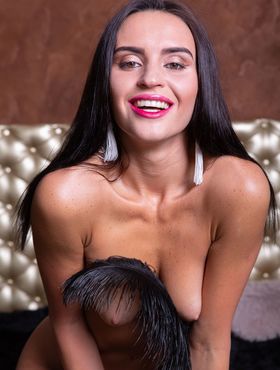 Sexy brunette Leyla Lee removes a mask and robes to pose nude with a feather