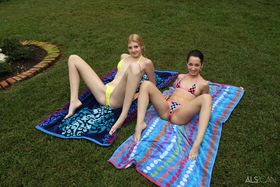 Short and tall lesbians remove bikinis before scissoring and fisting in yard