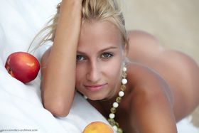 Flexible blonde Afina meditating naked and stretching on the beach