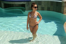 Hot Emma Brown peels her bikini to stuff a glass in her spread pussy poolside