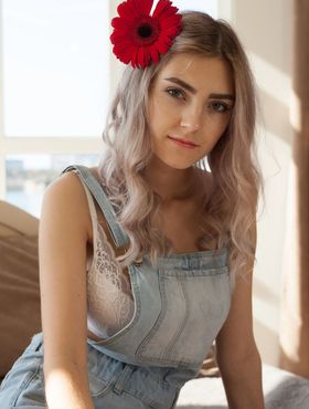 Young blonde Eva Elfie shows off her great body with a flower in her hair