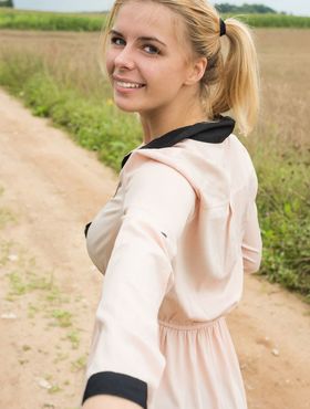 Young blonde Yelena gets totally naked in a farmer's field