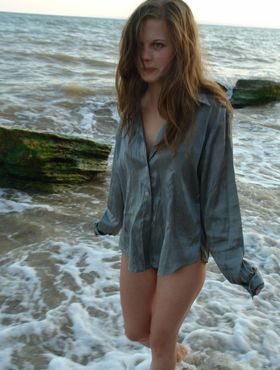 Nice teen girl Petra E removes her shirt after wading out into the ocean