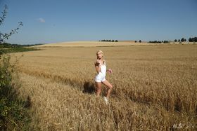 Thin blonde teen Kiara Cole fist fucks her pussy out in a farmer's field