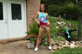 Solo girl Kymberly Brix pleases her horny pussy in garden with hose and tools