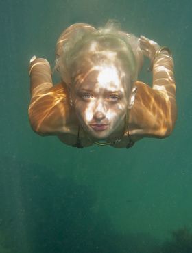 Ukrainian beauty Nika N swims underwater for nude posing inside a cave