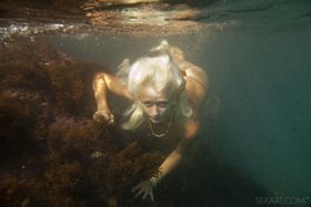 Ukrainian beauty Nika N swims underwater for nude posing inside a cave