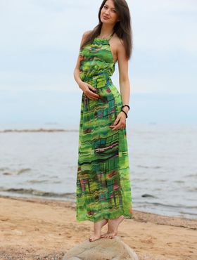Slender teen Ganna A drops her long dress to air perfect tits on the beach