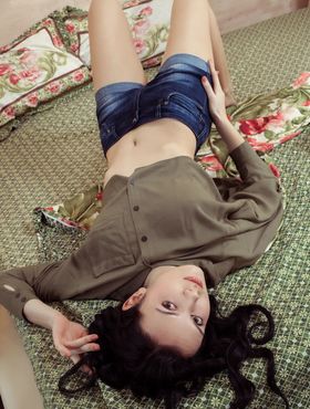Dark haired beauty Anatali frees her beautiful body from clothes on her bed