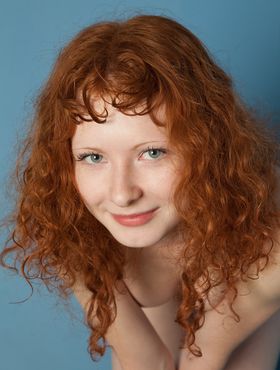 Pale redhead flaunts her firm breasts and hard nipples during nude solo poses