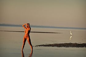 Caucasian teen Marilyn Winters see her naked reflection in a tidal pool