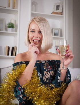 Cute blonde Sarika A pops the cork on champagne bottle before getting naked