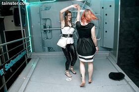 Party wear attired females get drenched by sprinkler system aboard submarine