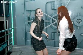 Clothed girls get caught in water sprinkler inside a submarine