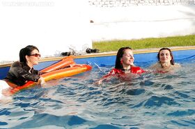 Fetish ladies have some wet fully clothed fun with her friends at the poolside
