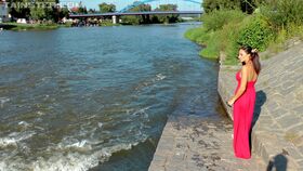 Busty brunette in red dress and exotic panties goes for a swim in local river