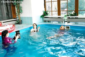Playful fetish ladies have some fully clothed fun in the pool