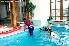 Playful fetish ladies have some fully clothed fun in the pool