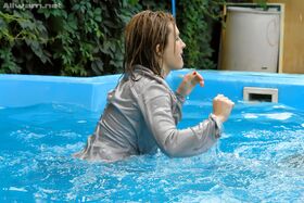 Tatiana Milovani has some fully clothed fun with her friend in the pool