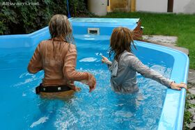 Tatiana Milovani has some fully clothed fun with her friend in the pool
