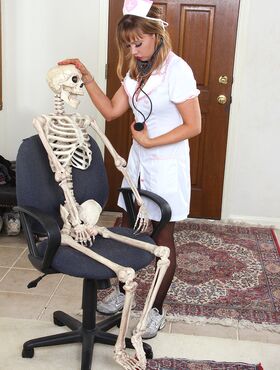 Sexy nurse Christy James peels her white uniform to facesit on a skeleton