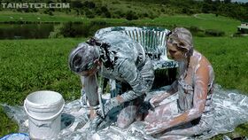 Fully clothed fashionistas have some messy and slimy fun outdoor