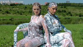 Fully clothed fashionistas have some messy and slimy fun outdoor