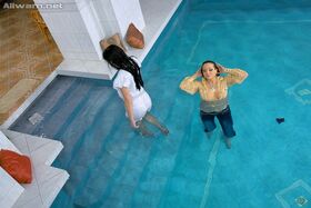 Fully clothed european vixens have some lesbian fun in the pool
