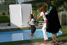 Clothed ladies jump into a pool before showing off their bare breasts