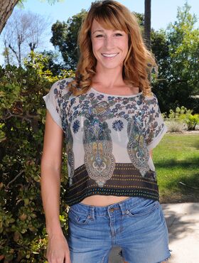 Redhead MILF Sophia K removes jean shorts as she disrobes under patio tree