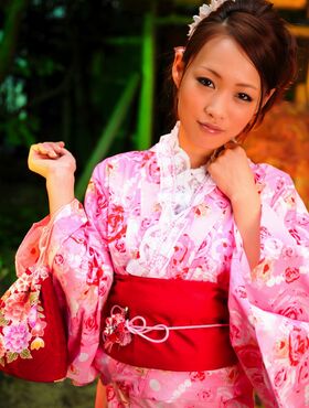 Cute Asian geisha teases in her bright pink kimono