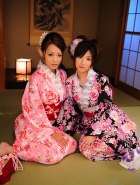 Two Japanese geishas model their pretty kimonos