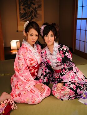 Two Japanese geishas model their pretty kimonos